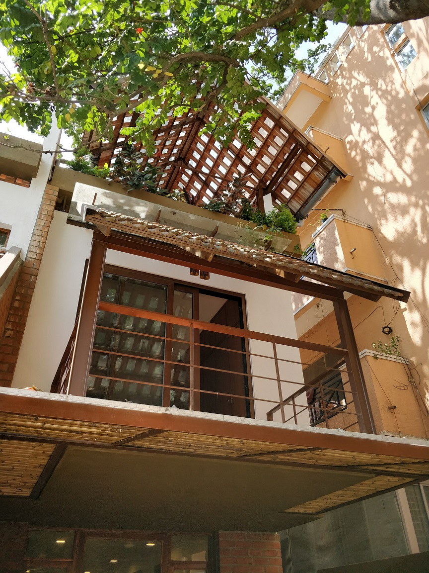 Contemporary home exterior with pergola and balcony