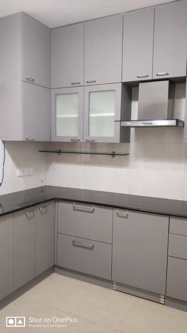 Matte grey modular kitchen with glass shutters